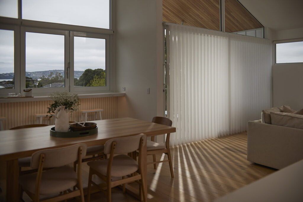 A Living Room With a Dining Table and Chairs and a Couch — TT Shutters & Shading In Ballina, NSW