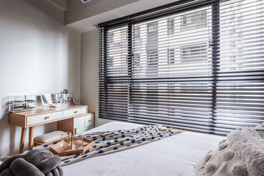A Bedroom With a Bed and Window With Blinds — TT Shutters & Shading In Ballina, NSW