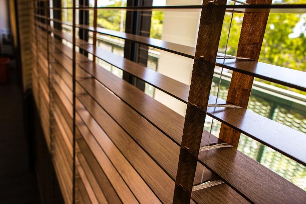 A Close Up of a Wooden Blind on a Window — TT Shutters & Shading In Lismore, NSW