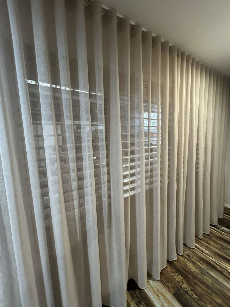 A Room With a Staircase and a Window With Curtains on It — TT Shutters & Shading In Lismore, NSW