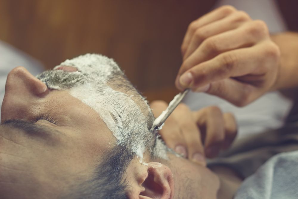 A Person Applies a Shaving Cream to Another Person Jawline — The Barber Social In Raymond Terrace, NSW