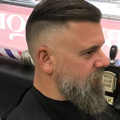 A Man With A Beard Is Getting His Hair Cut At A Barber Shop — The Barber Social In Raymond Terrace, NSW