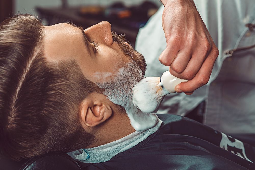 A Barber Uses a Shaving Brush to Apply White Lather to A Client Beard — The Barber Social In Raymond Terrace, NSW