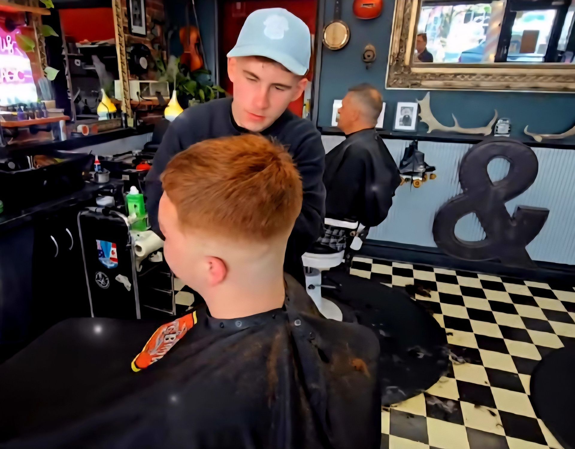 A Barber Gives a Person a Haircut in A Shop — The Barber Social In Raymond Terrace, NSW