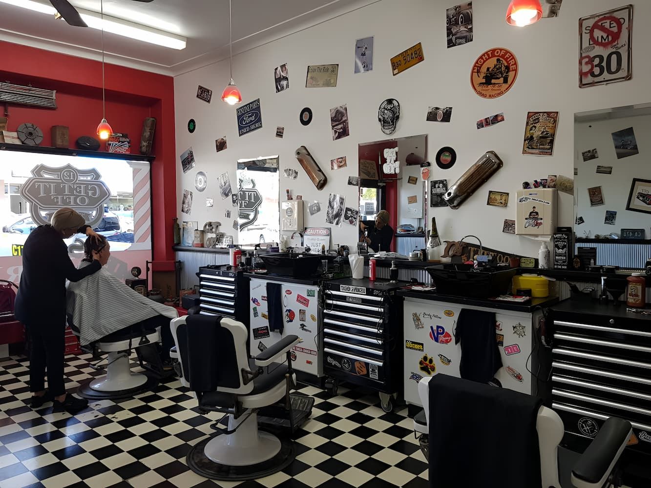 A Man Is Getting His Hair Cut In A Barber Shop — The Barber Social In Raymond Terrace, NSW