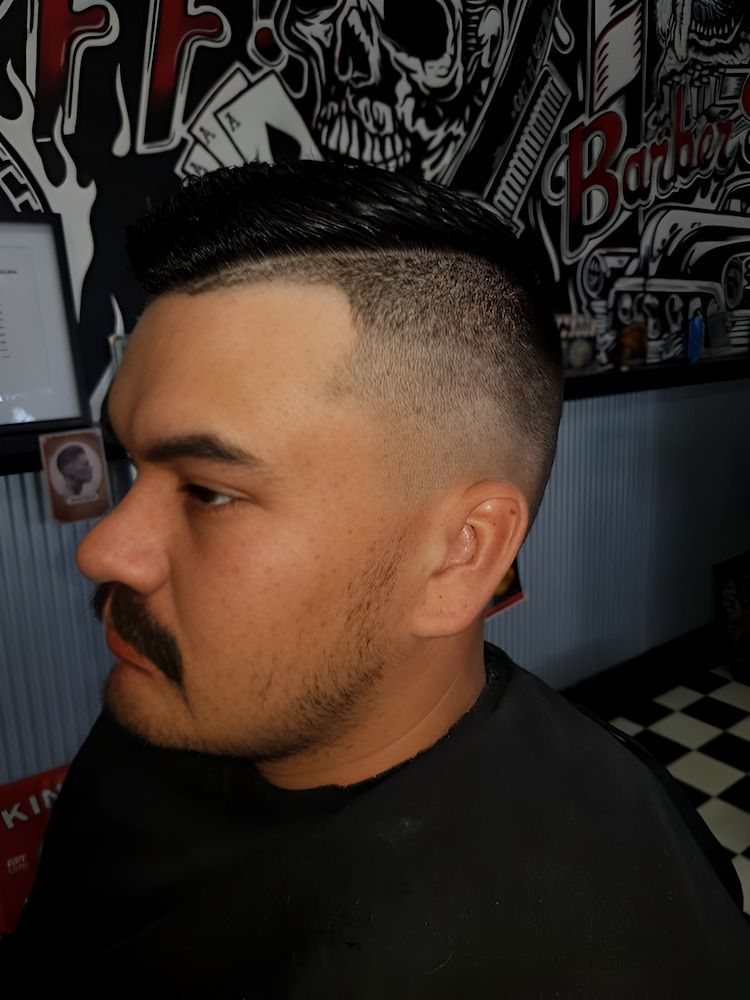 A Man With A Mustache Is Getting His Hair Cut At A Barber Shop — The Barber Social In Raymond Terrace, NSW