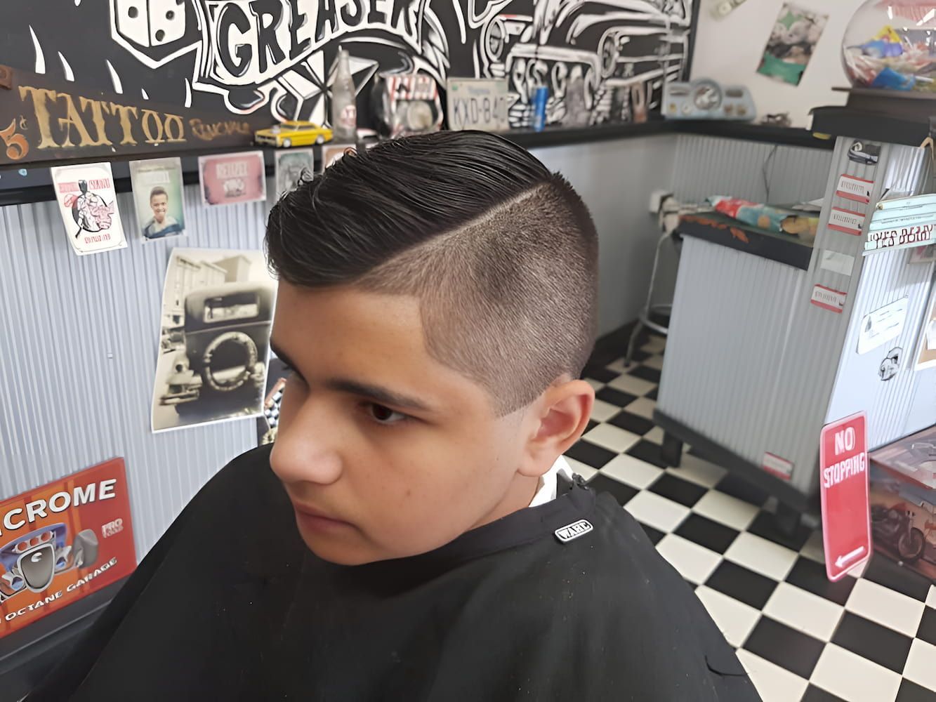 A Young Boy Is Getting His Hair Cut At A Barber Shop — The Barber Social In Raymond Terrace, NSW