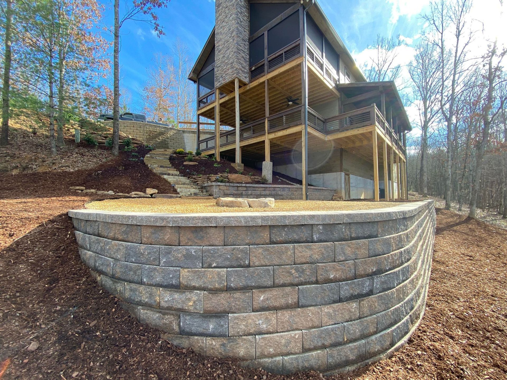 A large house with a brick wall in front of it