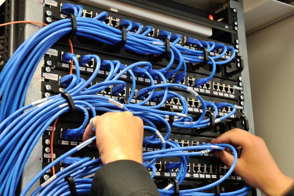 A Person is Working on a Server With Blue Wires — Leading Edge Computers in Forster, NSW