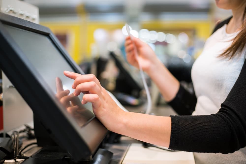 A Woman is Using a Computer in a Store — Leading Edge Computers in Forster, NSW