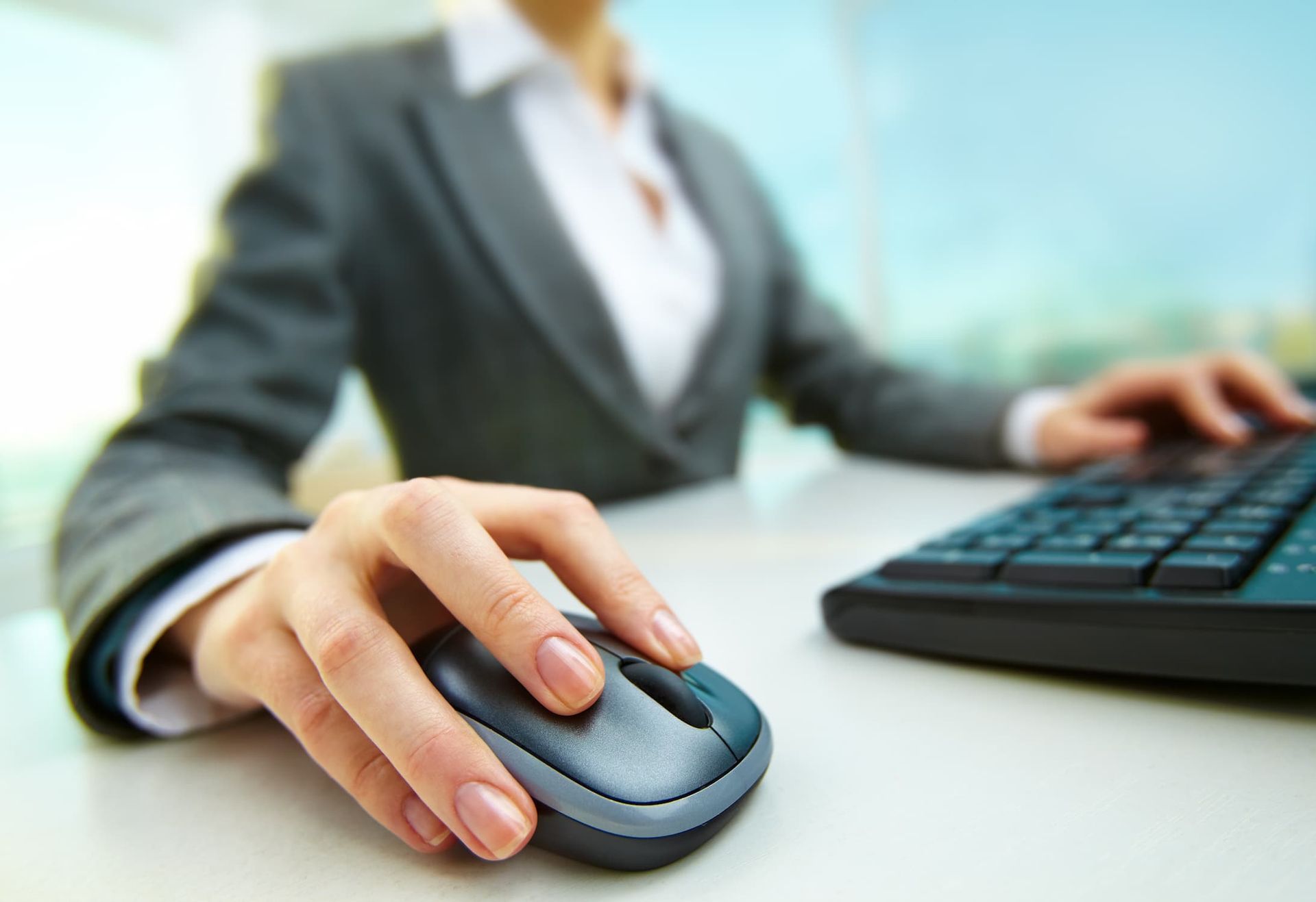 A Woman is Using a Computer Mouse and Keyboard — Leading Edge Computers in Forster, NSW