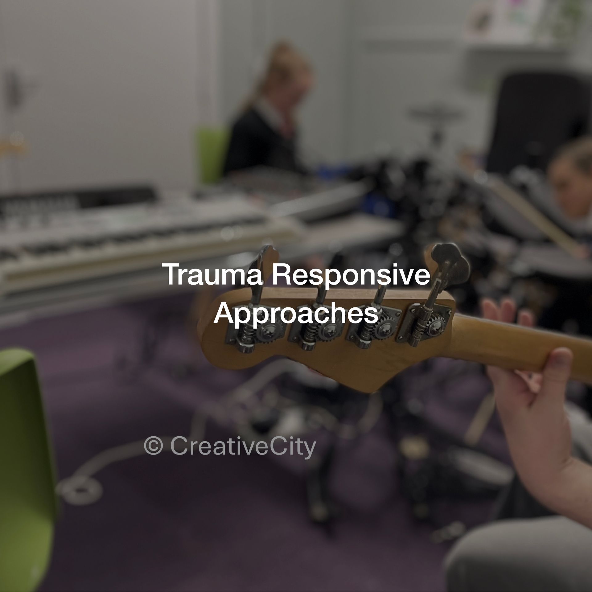 A person holding a guitar with the words trauma responsive approaches above it