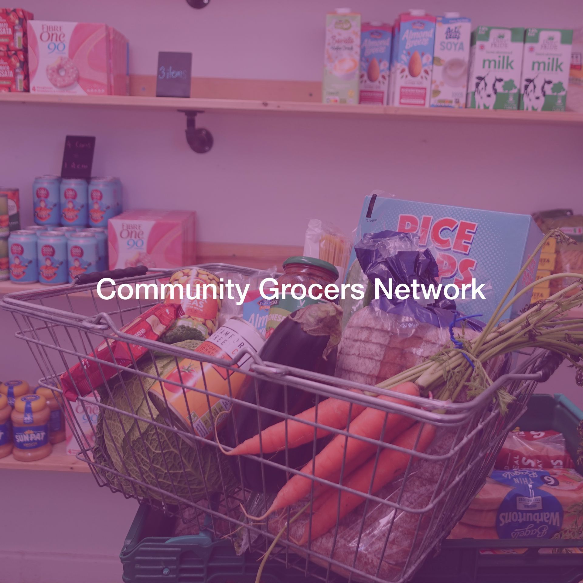 A shopping cart filled with groceries in front of a shelf.