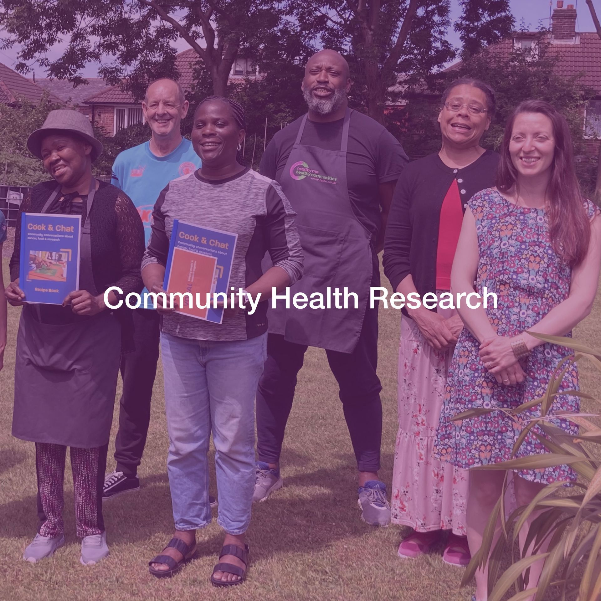 A group of people posing for a picture with the words community health research written above them