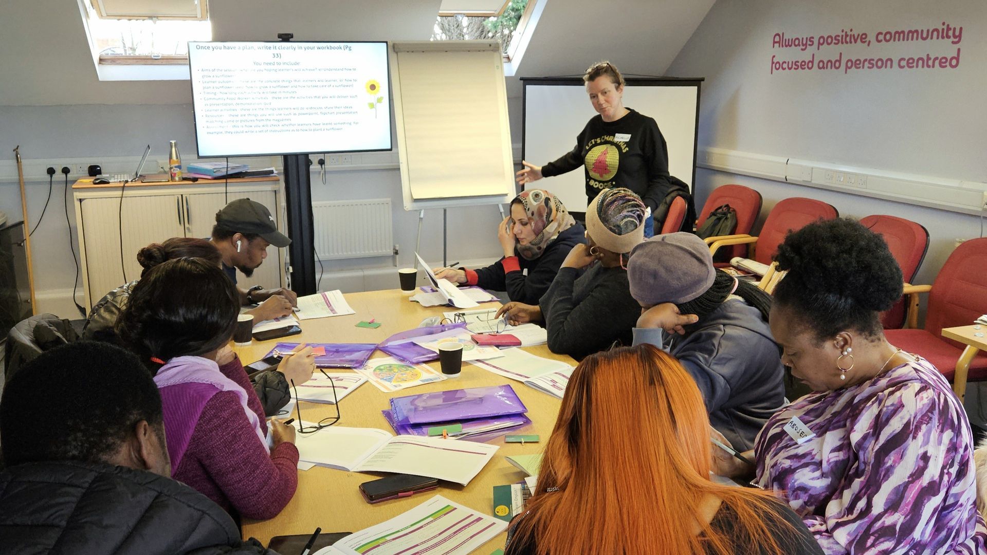 A group of people are sitting around a table in a room.
