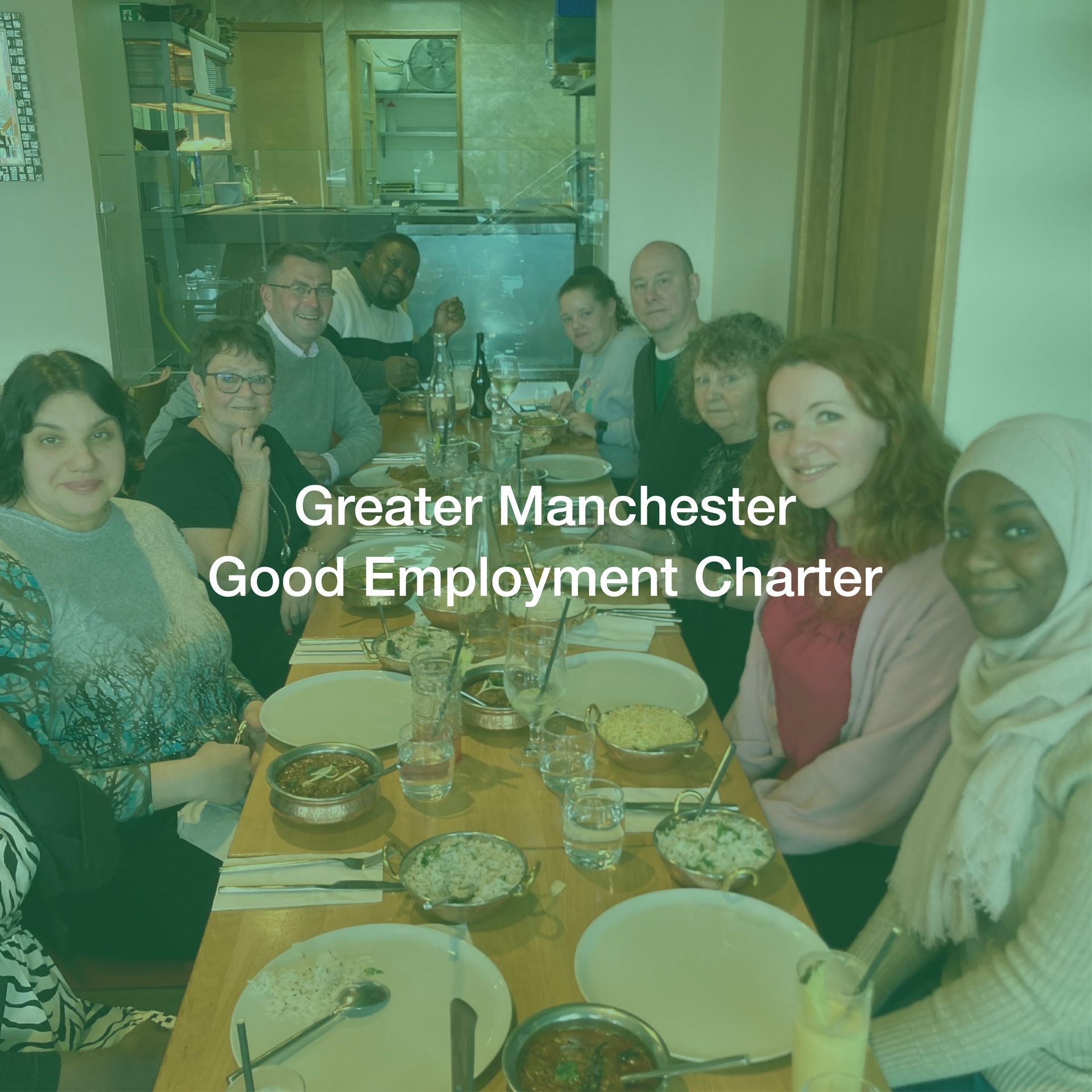 A group of people are sitting at a table with plates and bowls of food.