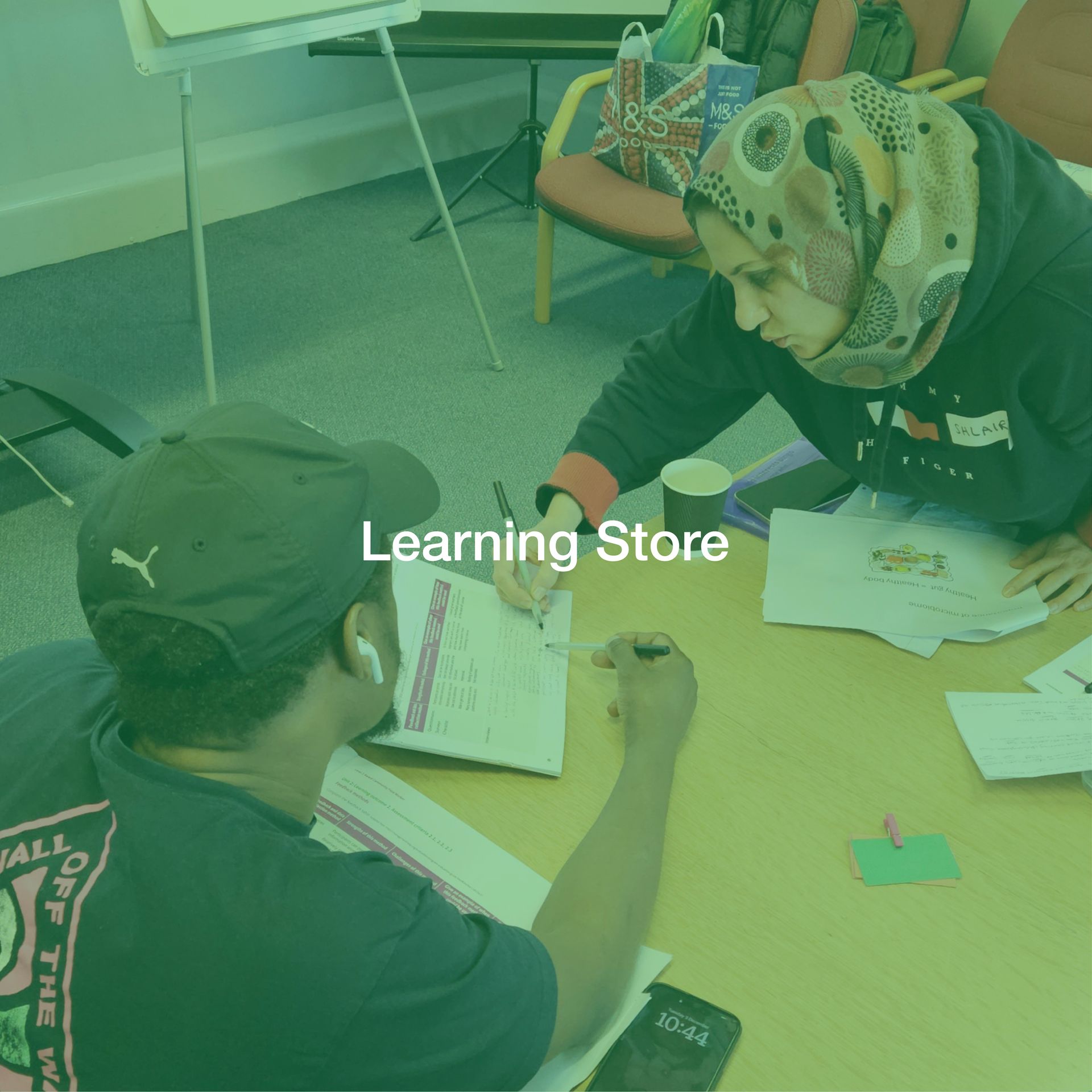 A man and a woman are sitting at a table in a learning store