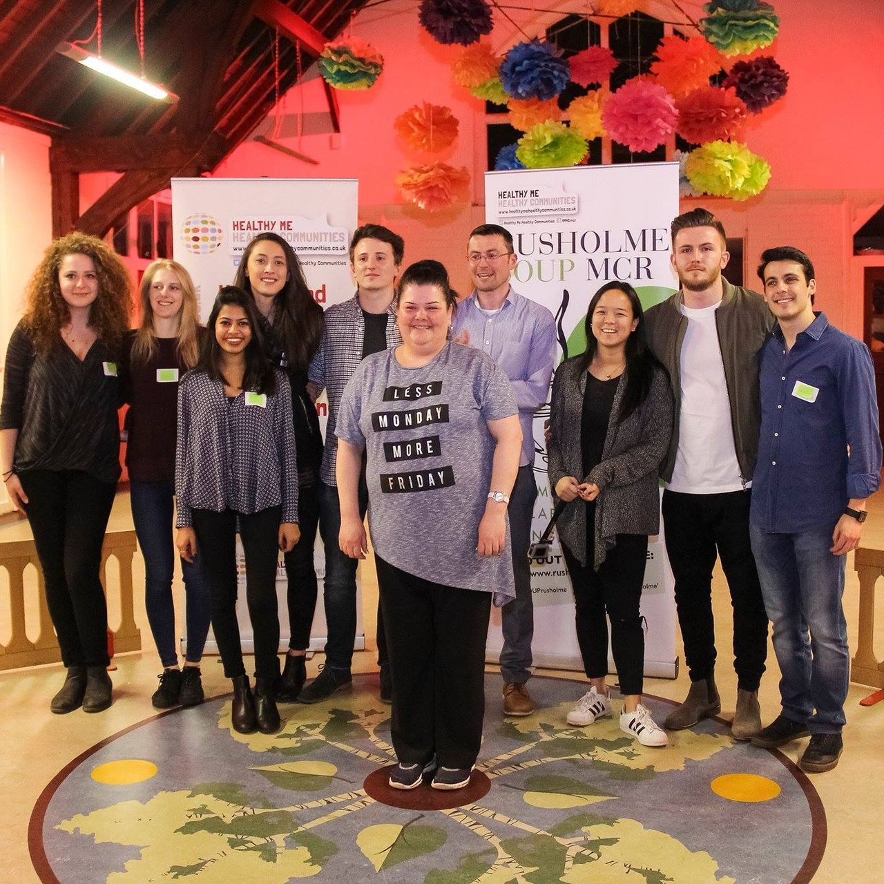 A group of people posing for a picture with one woman wearing a shirt that says ' i 'm worth it '