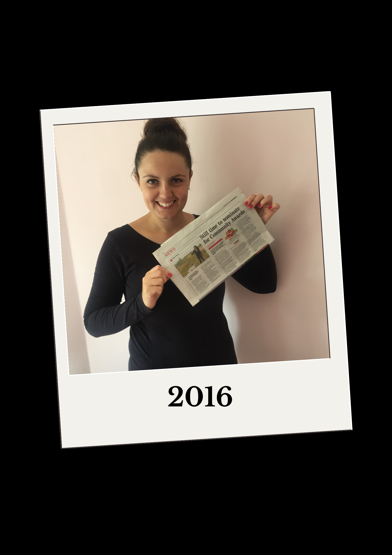 Lisa standing with a newspaper article about the princes trust she is in