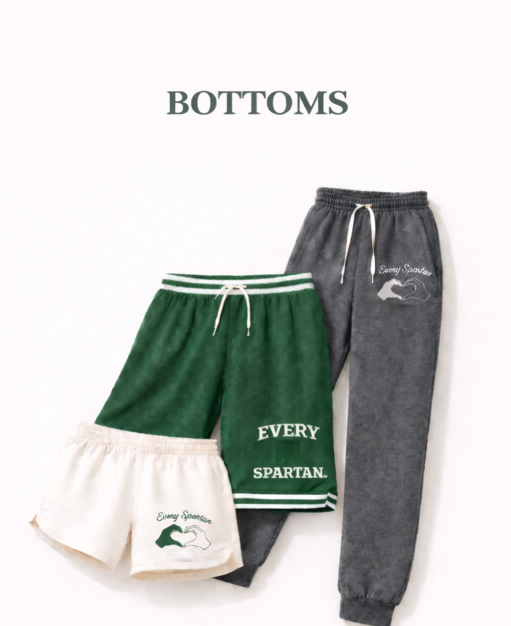 Three pairs of bottoms: cream shorts, green shorts, and grey sweatpants with drawstrings.
