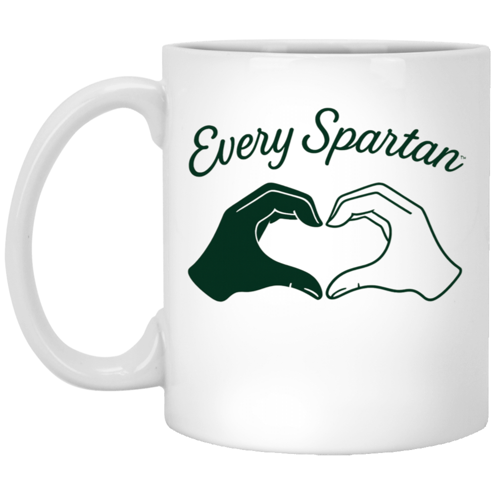 White mug with “Every Spartan” text and two hands forming a heart in dark green and white.