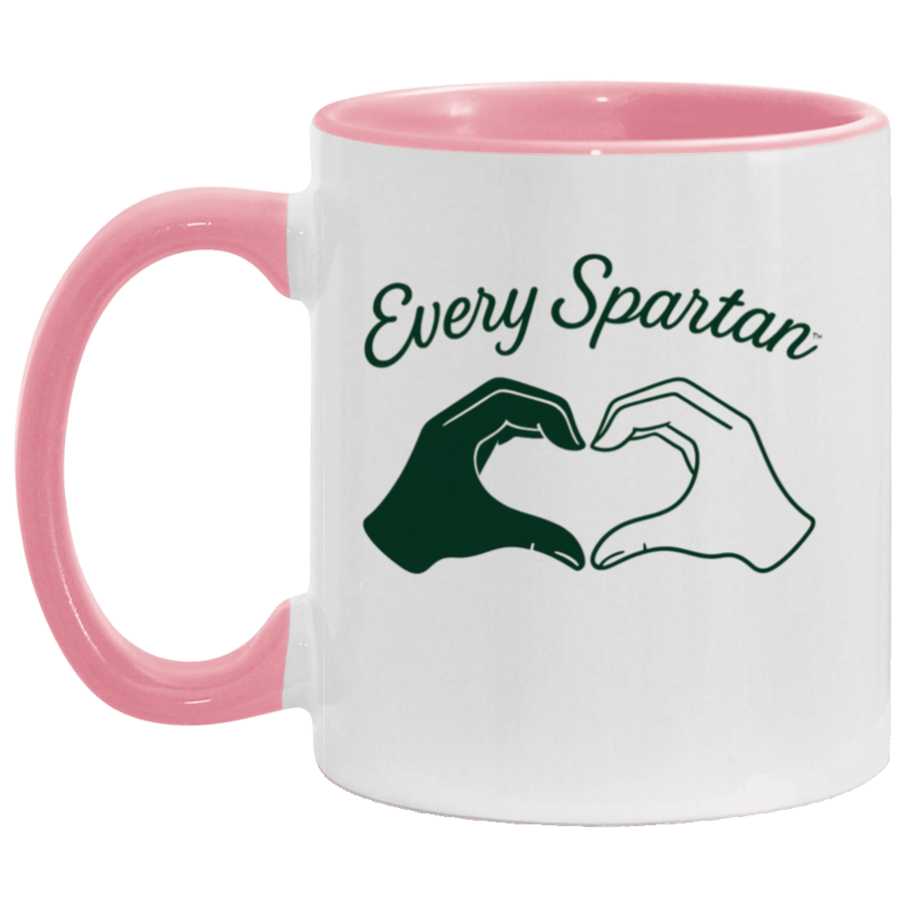Pink mug with “Every Spartan” text and two hands forming a heart shape