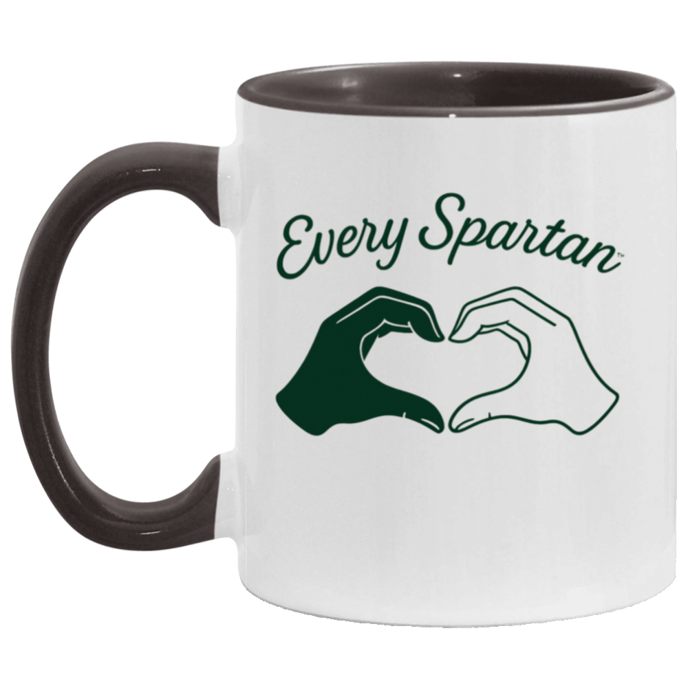 White mug with dark handle and rim, reading “Every Spartan” above two hands forming a heart