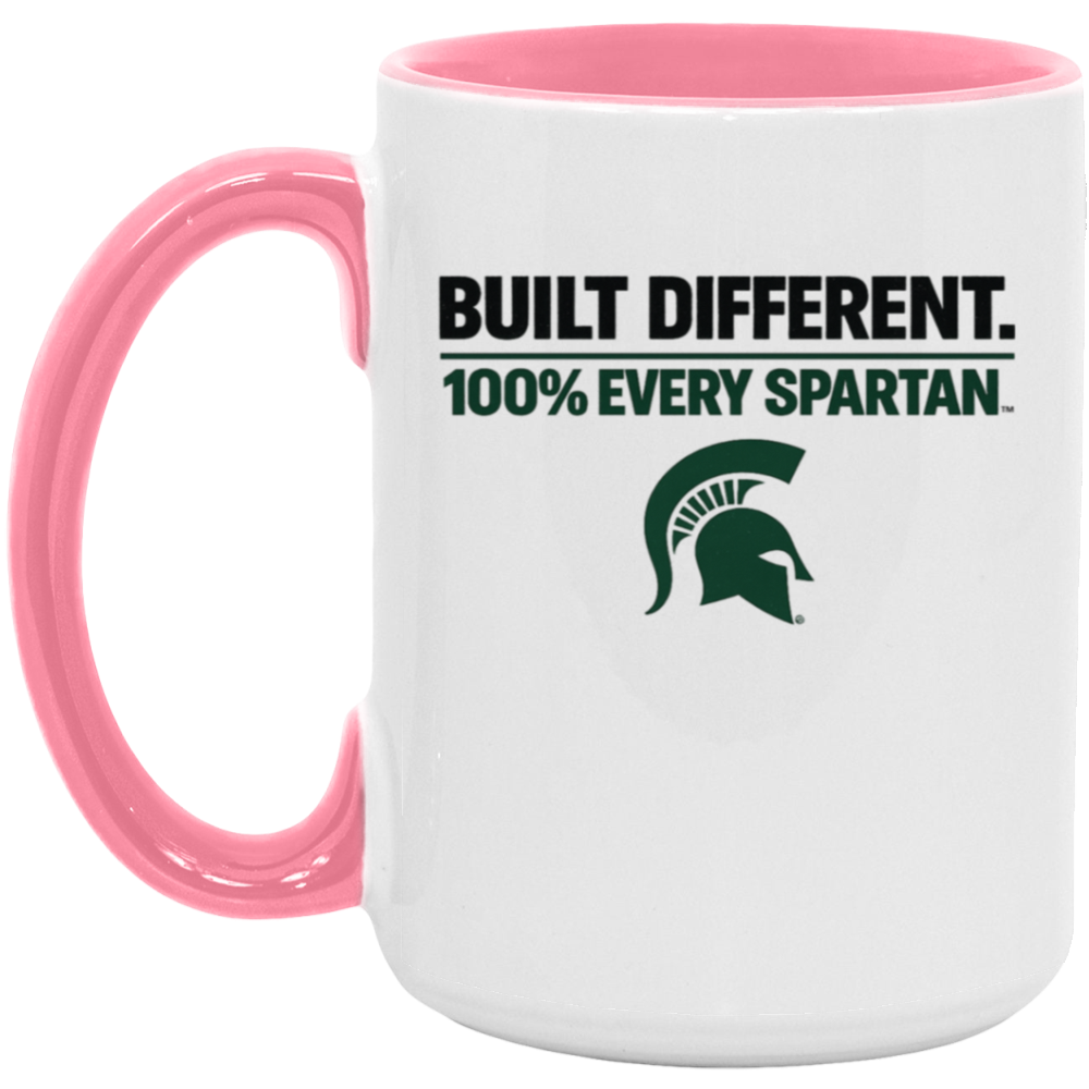 White mug with pink handle and rim, printed with “BUILT DIFFERENT. 100% EVERY SPARTAN.” and a green Spartan logo