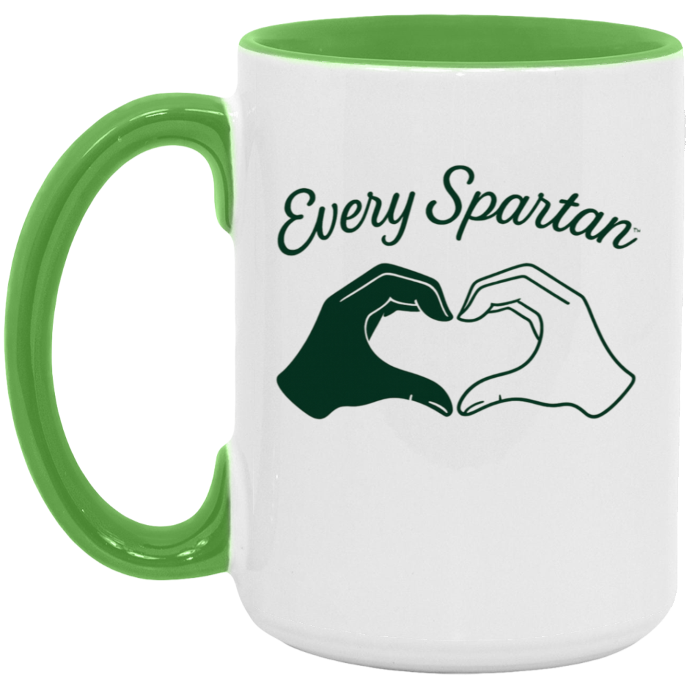 White mug with green handle and rim, reading “Every Spartan” with two hands forming a heart shape.
