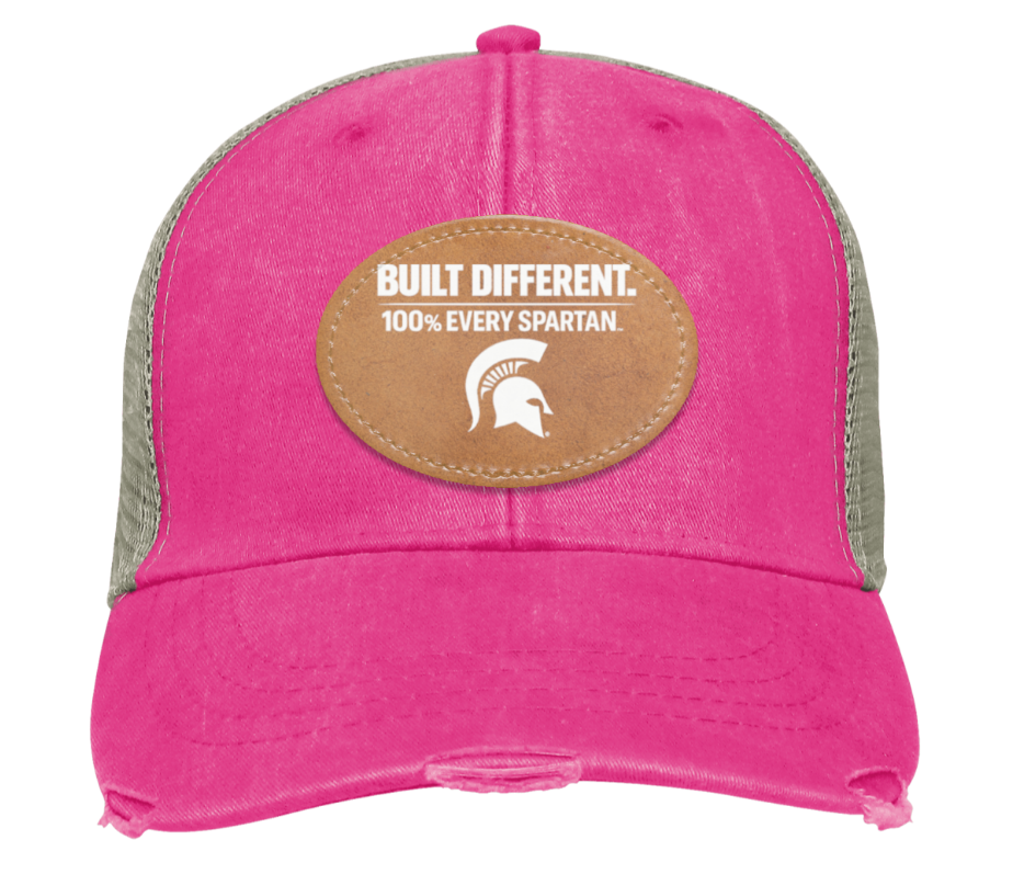 Pink baseball cap with a tan “Built Different” Ever Spartan patch on the front
