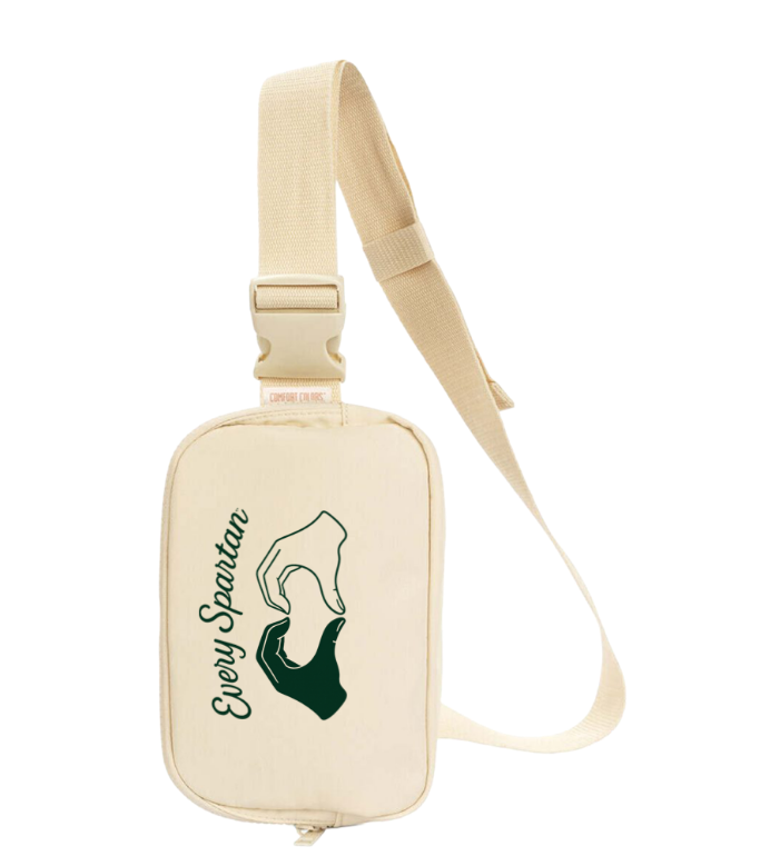 Cream crossbody bag with a beige strap and green “Everyday Spirit” logo on the front.
