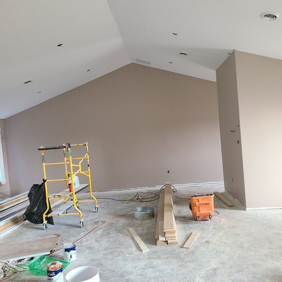 An empty room with a scaffolding and a vaulted ceiling