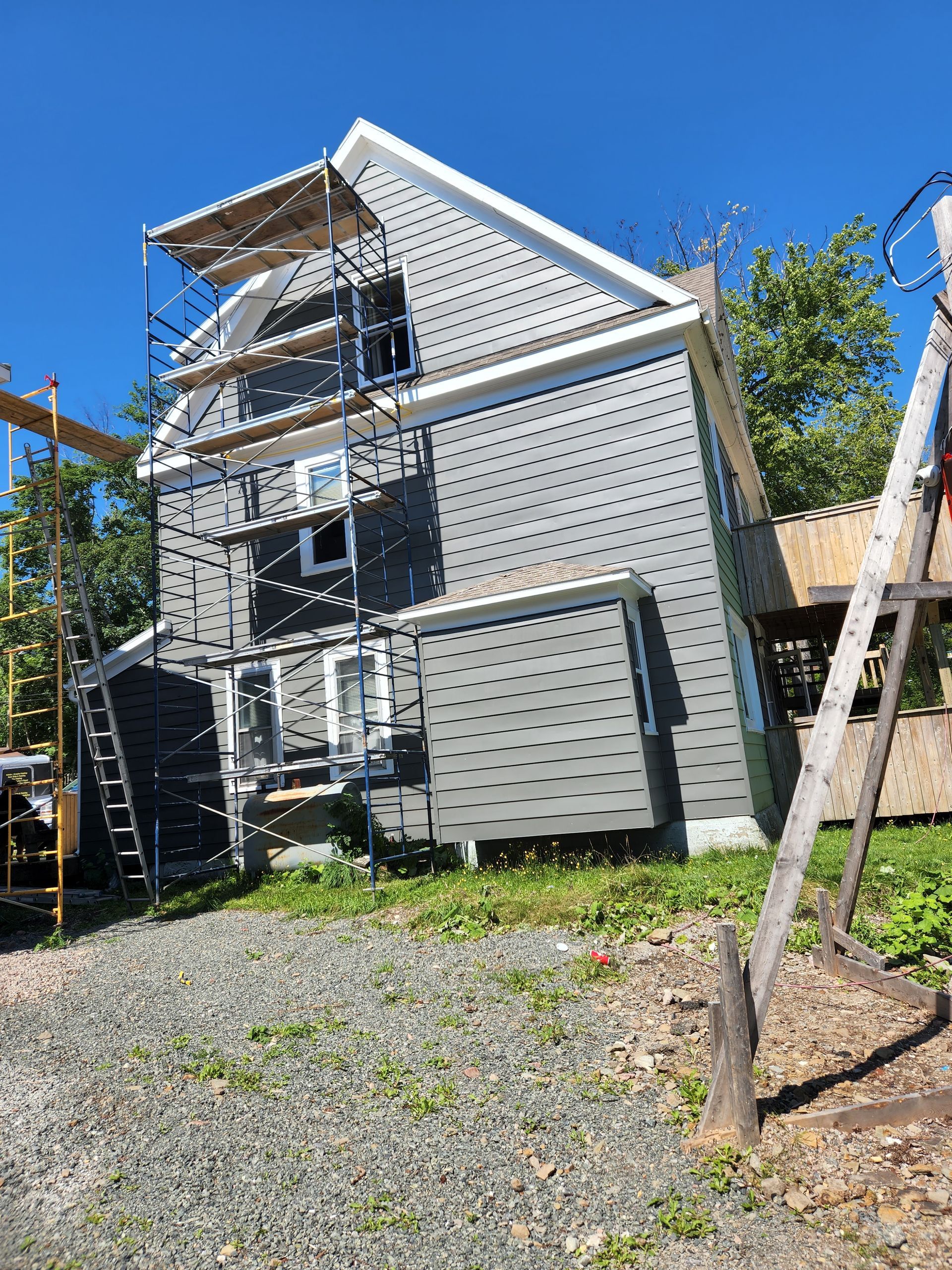 A house is being remodeled with scaffolding around it.