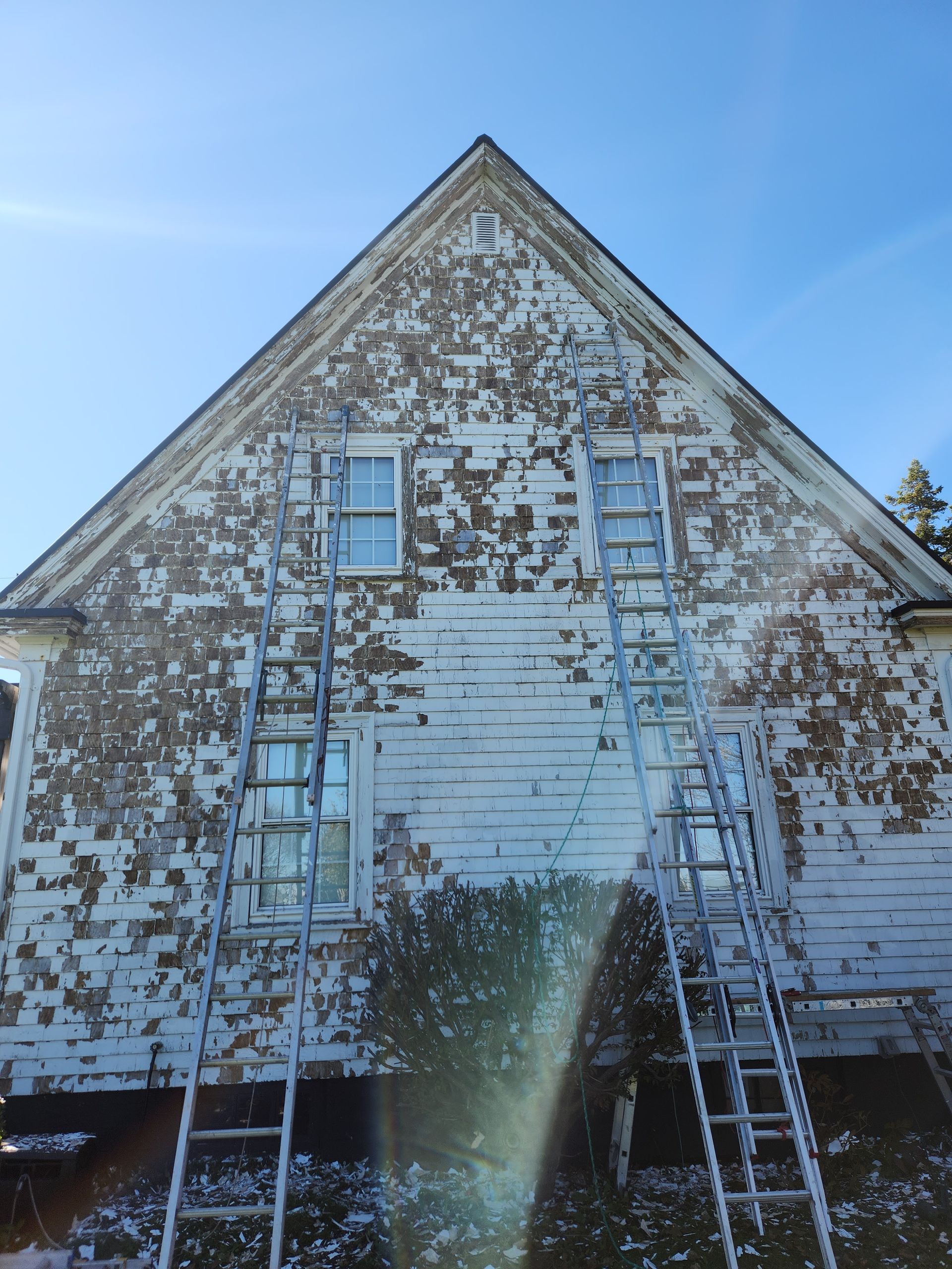 A white building with a blue sky in the background