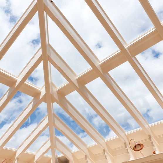 Looking up at the sky through a glass roof