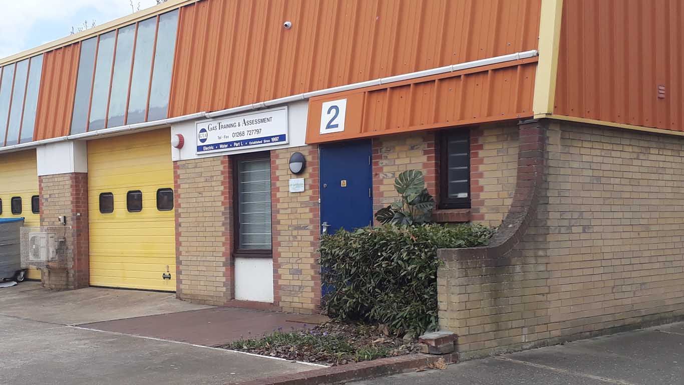 A large brick building with a yellow garage door and a blue door.