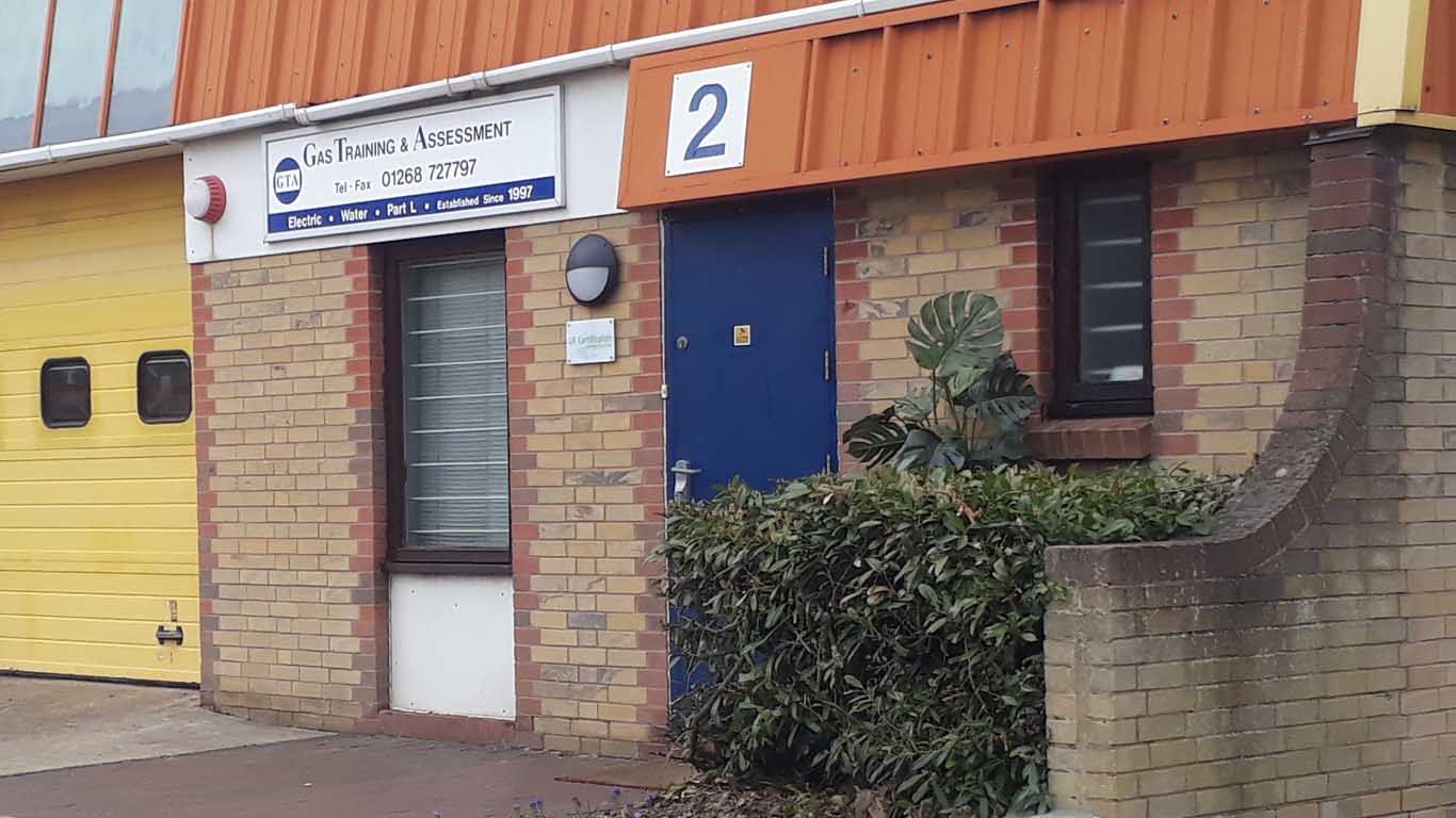 A brick building with a blue door and a yellow garage door.