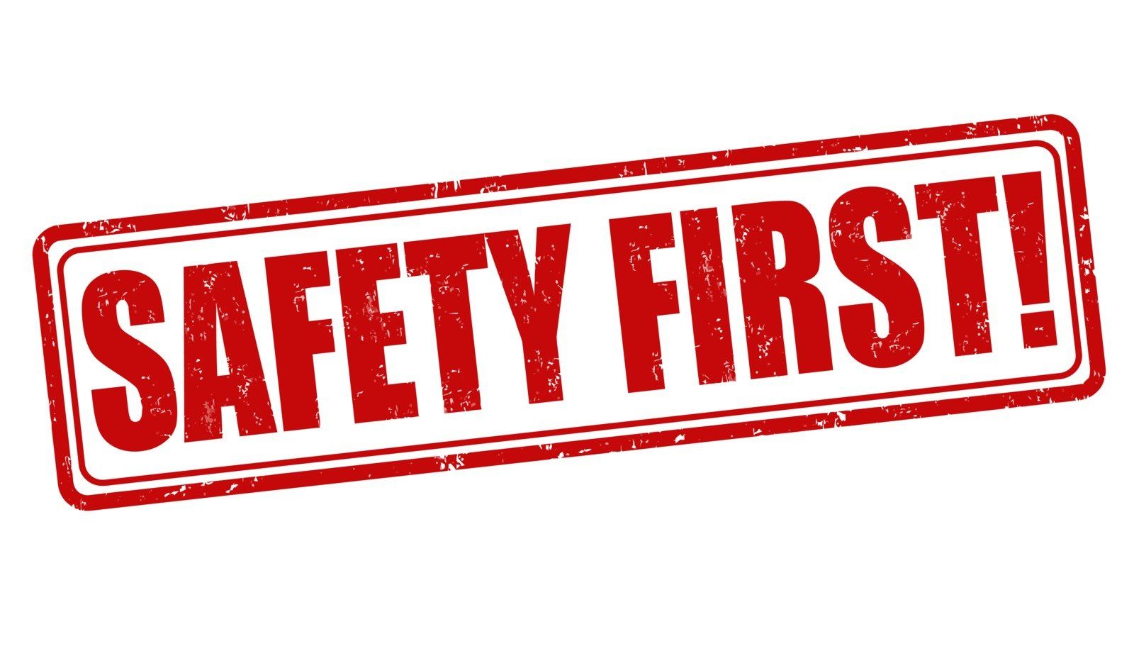 A red stamp that says `` safety first '' on a white background.