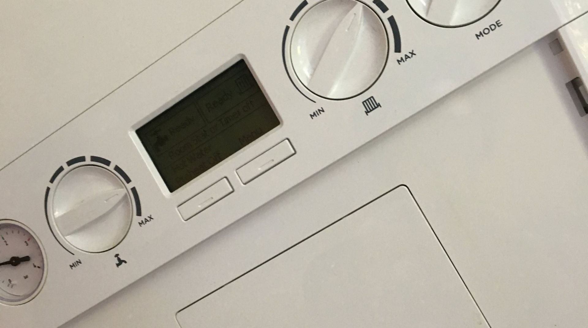 A close up of a control panel on a white surface.