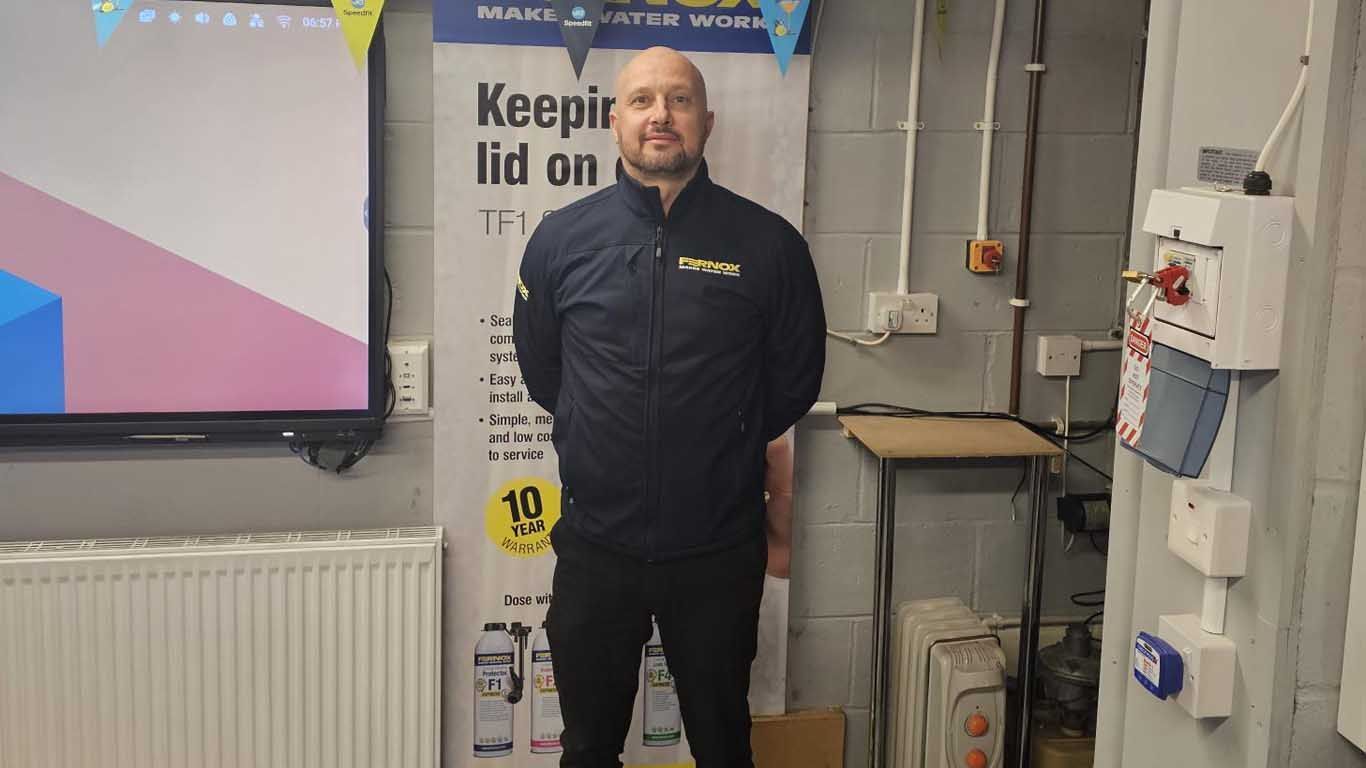 A man is standing in front of a sign that says `` keep it lid on ''.
