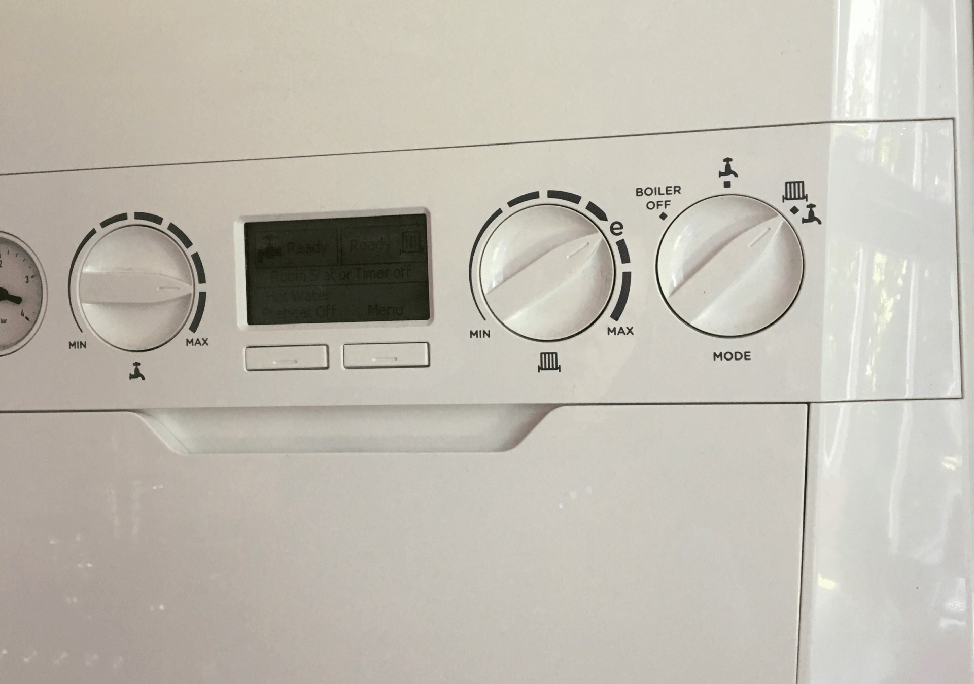 A close up of a white appliance with a digital display