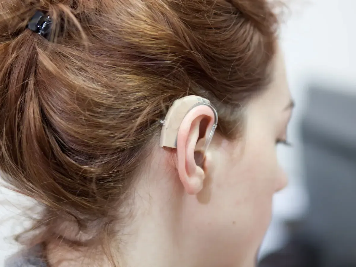 A woman with a hearing aid