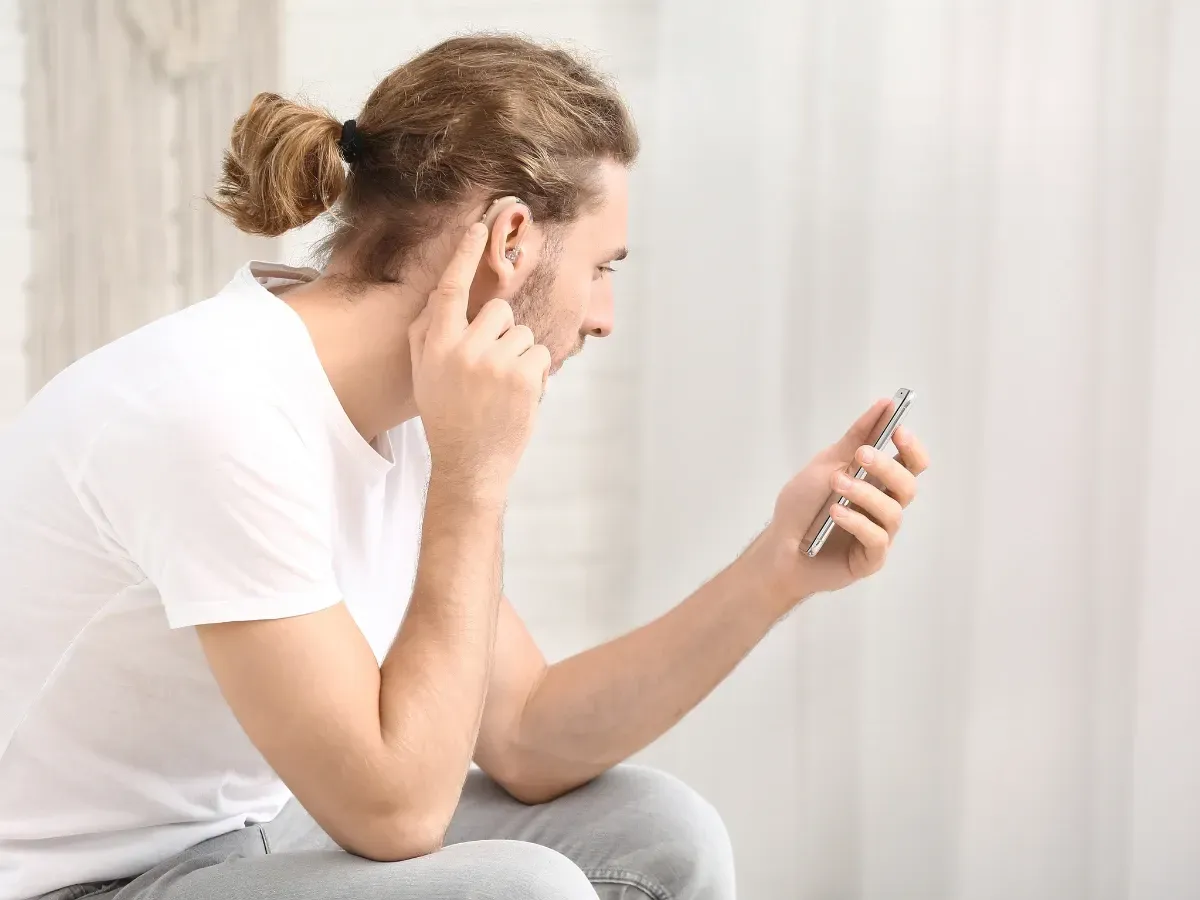 What is a hearing amplifier, and how does it differ from a hearing aid?