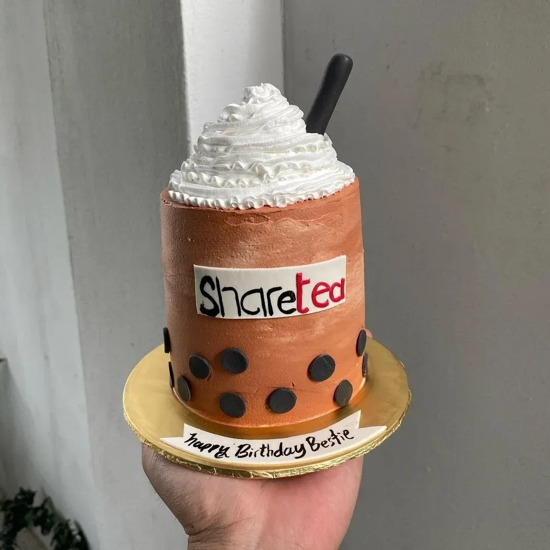 Handmade cake with white frosting, black dots, and a 