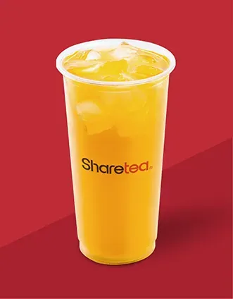 Orange iced drink in a clear plastic cup with a strawless lid on a red background, labeled “Sharetea”.