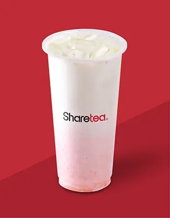 Tall cup of white milk tea with ice, branded 