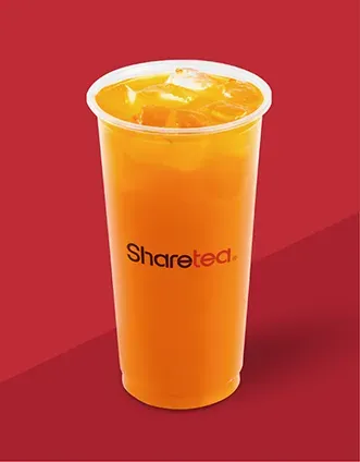 Orange iced drink in a clear plastic cup labeled “Sharetec” on a red background