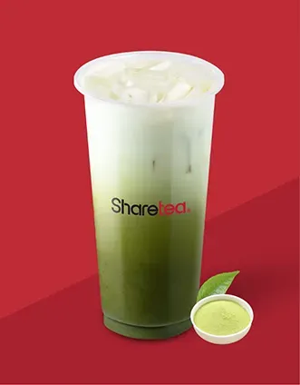Tall iced green drink in a clear cup with the Sharetea logo, beside a lime slice on a red background