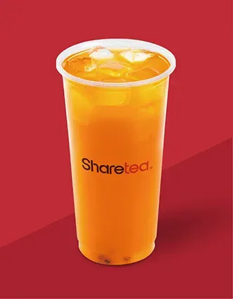 Clear plastic cup of orange drink with ice on a red background, labeled “Sharetea”