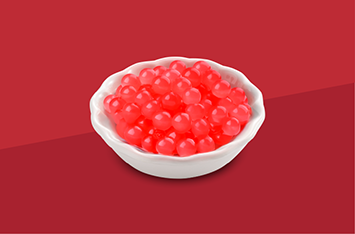 White bowl filled with red caviar on a red background